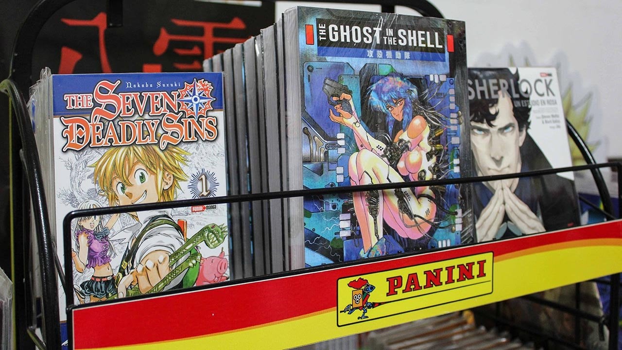 Se ve una estantería con mangas japoneses, el de seven deadly sins, ghost in the shell y sherlock. Abajo aparece la marca Panini